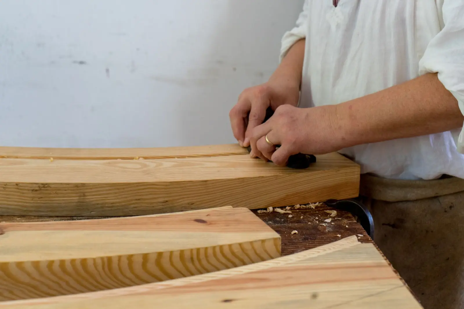 Carpenter planing a length of timber