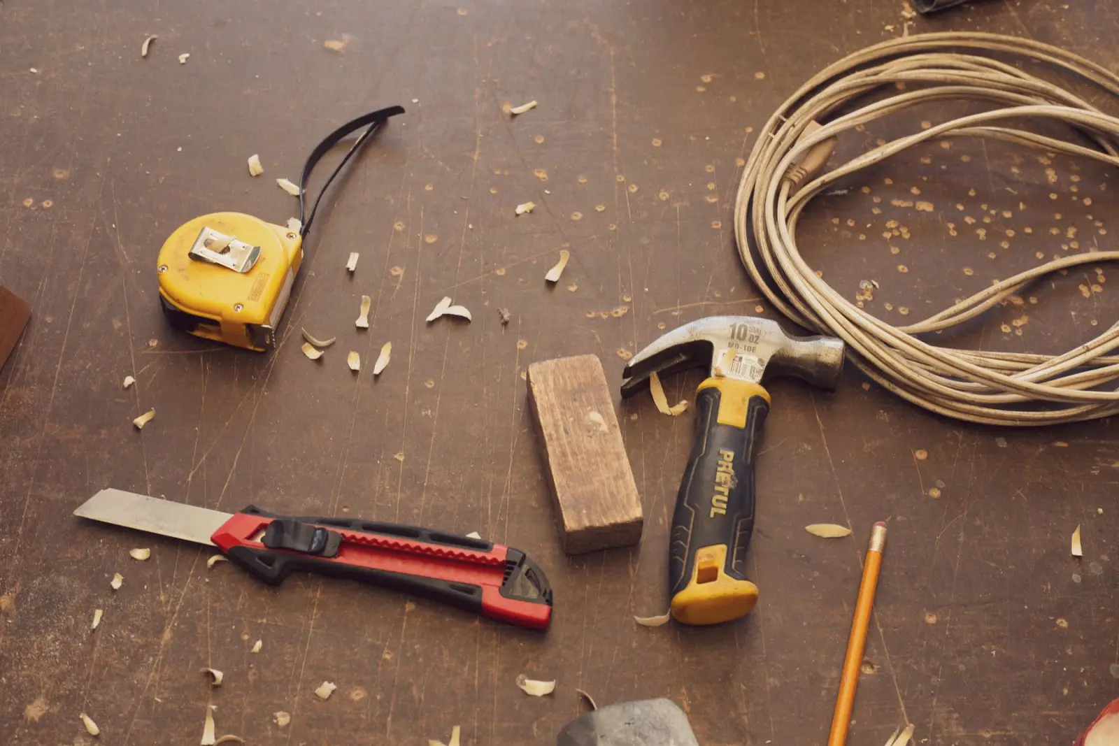 Hammer, tape measure and tools on a workbench